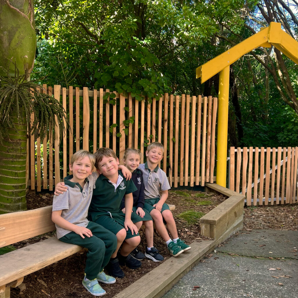 Children sitting together and smiling