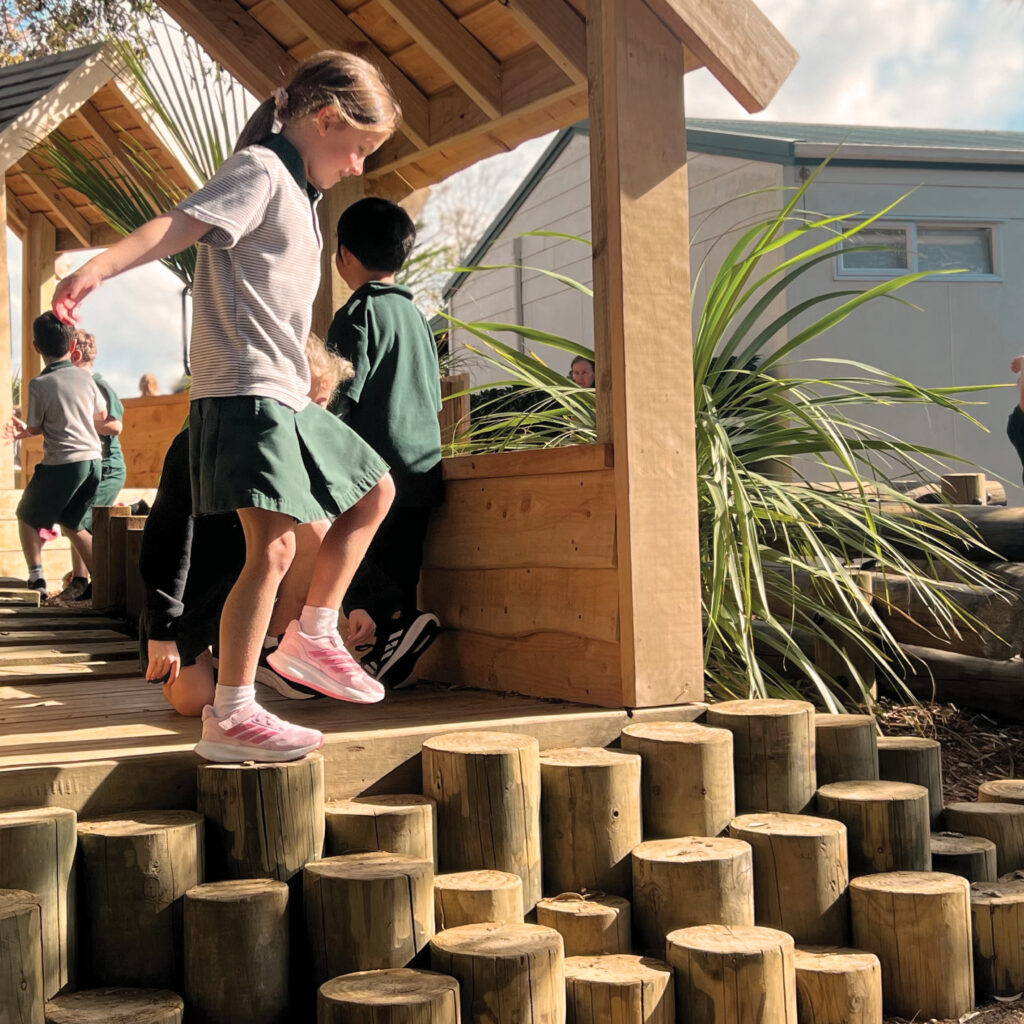 Girl balancing on log steppers